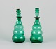 A pair of decanters in green art glass from a Swedish glassworks. Mouth-blown in 
Art Deco style.