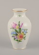 Herend, Hungary. Porcelain vase hand-painted with polychrome flower motifs and 
gold edge.