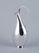 Hugo Grün, Danish silversmith. Modernist pitcher in sterling silver in an 
organic and sleek design.