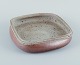 Nils Kähler for Kähler, ceramic bowl on four low feet.
Square shape. Glaze in earthy tones.