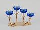 Gunnar Ander for Ystad Metall, Sweden. Candlestick holder in brass and blue art 
glass shaped like flowers. For four candles.