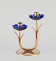 Gunnar Ander for Ystad Metall, Sweden. Candlestick holder in brass and blue art 
glass shaped like flowers. For two candles.