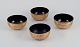 Four Asian bowls made of papier-mâché. Decorated in gold and black with 
traditional motifs.