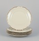 KPM, Poland. A set of six porcelain lunch plates.
Cream-colored with gold rim decoration.