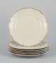 KPM, Poland. A set of six dinner plates in cream-colored porcelain.
Decorated with a gold rim.