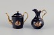 Limoges, France. Miniature Coffee pot and water jug in porcelain, decorated with 
22-karat gold leaf and a beautiful royal blue glaze. Scène galante.
