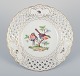 Meissen, Germany. Open lace porcelain plate. Hand-painted with a bird motif and 
insects, gold trim.