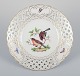 Meissen, Germany. Open lace porcelain plate. Hand-painted with a bird motif and 
insects, gold trim.