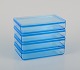 Rauff & Møldrup for Holmegaard. Set of four Thurø storage boxes in turquoise 
blue art glass.