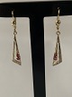 Gold earrings in 14 carat gold, with 2 red rubies and a diamond.