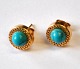 Pair of 18 
karat red gold 
ear sticks with 
turquoises, ...