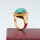 Ring of 14k 
gold, set with 
a large 
turquoise