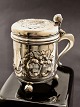 Silver mug with old silver schilling coin
