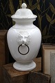 Old glazed stoneware lidded jar with lion heads on the side...