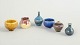 L'Art presents: Set of six miniature ceramic bowls and vases.