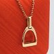 Antik Damgaard-Lauritsen presents: Ole Lynggaard; Stirrup pendant in 14k gold