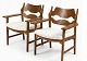 Lundin Antique presents: A pair of Razorblade armchairs by Henning Kjaernulf covered with new lambskin. ...