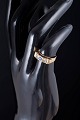 L'Art presents: 14 carat gold ring with blue and colourless stones.