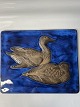Relief of ceramics with a motif of ducks on a blue ...