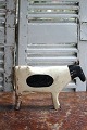 Decorative, old milking cow in carved wood with ...