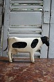 Decorative, old milking cow in carved wood with ...