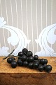 Old bunch of grapes with dark grapes made of cast glass ...