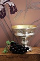 K&Co. presents: Decorative, old bunch of grapes in glass with vine leaves in green jade...
