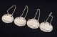L'Art presents: Four silver decanter labels.