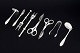 Collection of eight silver-plated serving utensils.