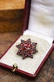 Old star shaped brooch with beautiful red garnets...