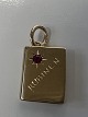 14 karat gold. Book with inlaid red ruby.Charms / ...