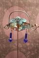Unique old flower stick in patinated copper with small angel and glass beads made by jewelry artist Torben Hardenberg.