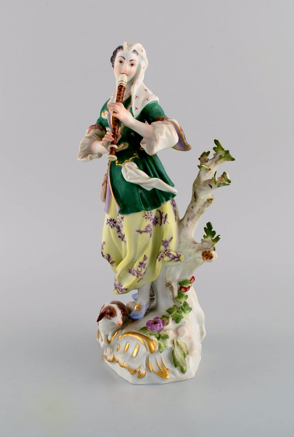  Antique Meissen porcelain figurine. Woman playing flute.  Late 19th century. *