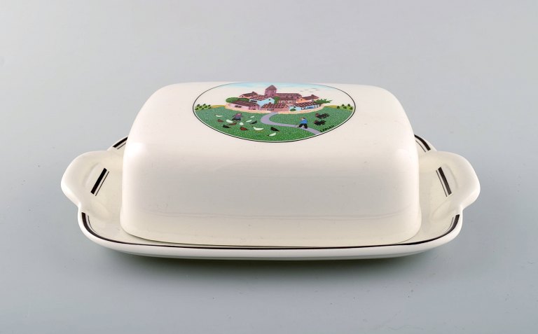 Villeroy & Boch Naif smørbeholder med underfad i porcelæn dekoreret med 
naivistisk landsbymotiv.