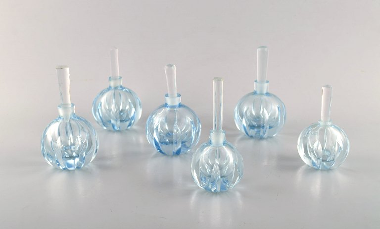 Edward Hald for Orrefors. En samling på seks mundblæste art deco flakoner i 
lyseblåt kunstglas. Designet i 1940