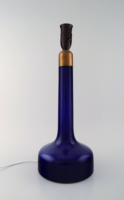 Holmegaard table lamp in dark blue art glass with brass mounting. Danish design, 
1960