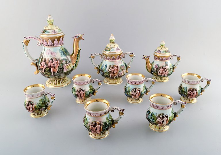 Capodimonte, Italy. Porcelain coffee service decorated with erotic scenes. 
Complete for six people with sugar bowl and creamer. 1930