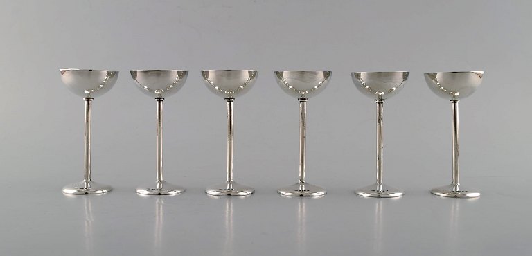 Carl Andreas Kjernås, Swedish silversmith. A set of six modernist hunting / 
vodka beakers in silver. Dated 1921.
