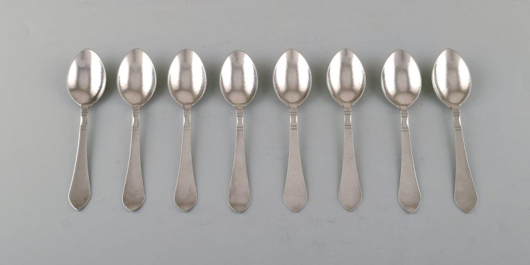 Georg Jensen Continental cutlery. Eight dessert spoons in hammered sterling 
silver.
