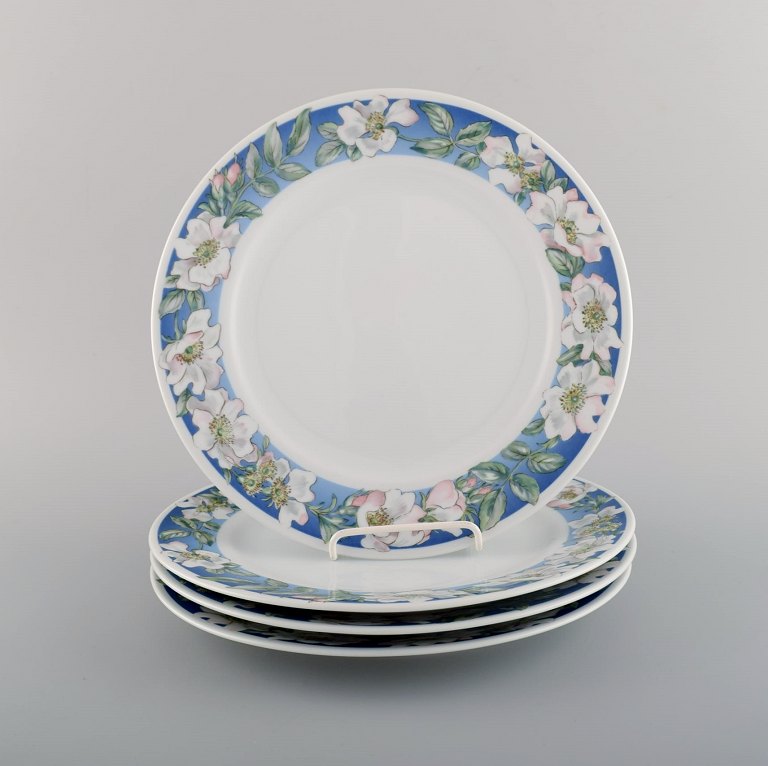 Four Royal Copenhagen White Rose dinner plates with blue border, white flowers 
and foliage. Dated 1992-1999.
