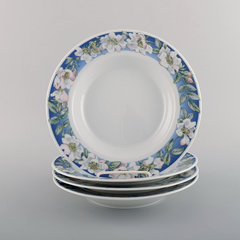Four Royal Copenhagen White Rose deep plates with blue border, white flowers and 
foliage. Dated 1992-1999.
