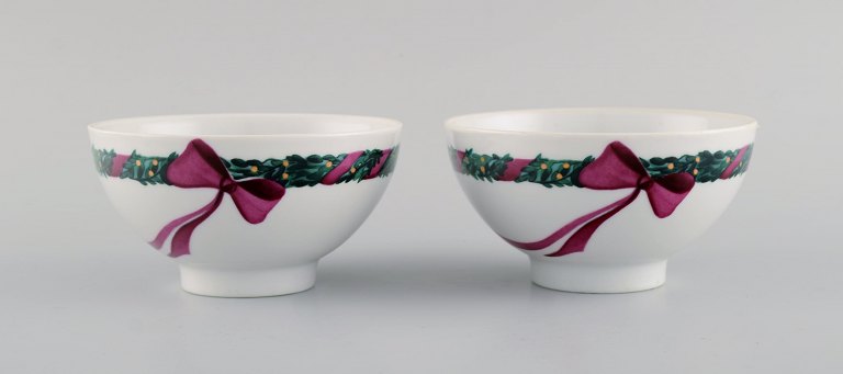 Two Royal Copenhagen Jingle Bells bowls decorated with spruce and ribbon.
