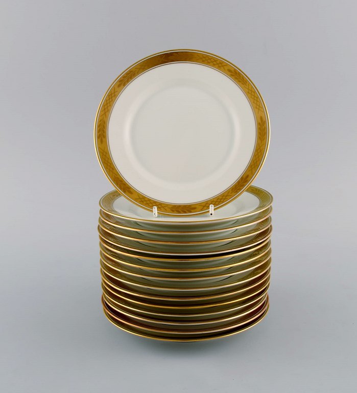 Royal Copenhagen stel nr. 607. 15 kagetallerkener i porcelæn. Guldkant med 
bladværk. 1960