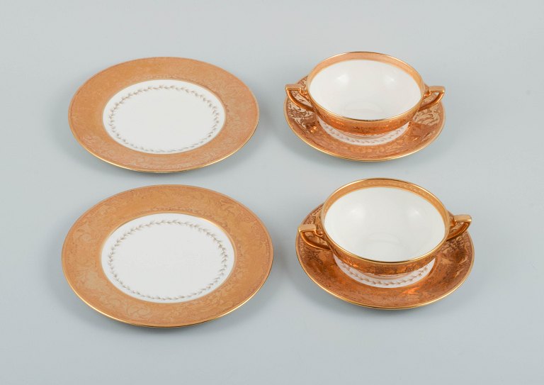 Le Tallec, France. Two pairs of bouillon cups with accompanying saucers, and two 
plates.