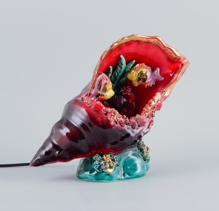 Vallauris, France. Decorative table lamp in glazed ceramic shaped like a conch.