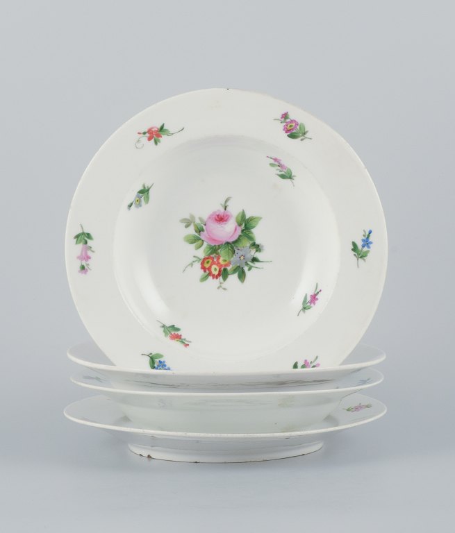Royal Copenhagen, set of four rare and antique Saxon Flower porcelain plates. 
Hand-painted with polychrome floral motifs. Three deep plates and one dinner 
plate.