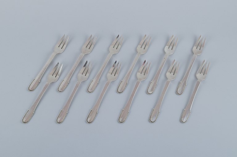 Georg Jensen Beaded.
A set of twelve cake forks in sterling silver.