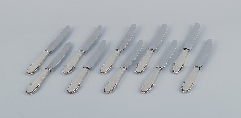 Georg Jensen Beaded.
A set of ten fruit knives in sterling silver. Stainless steel blade.