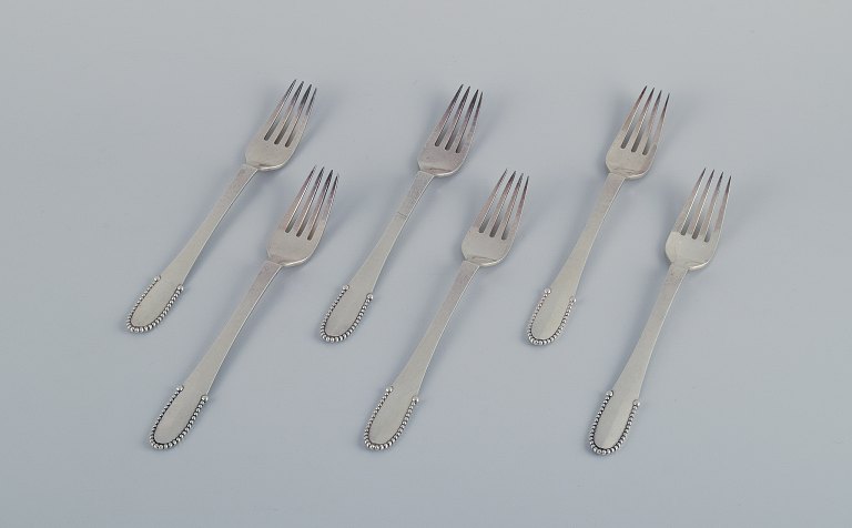 Georg Jensen Beaded.
A set of six lunch forks in sterling silver.