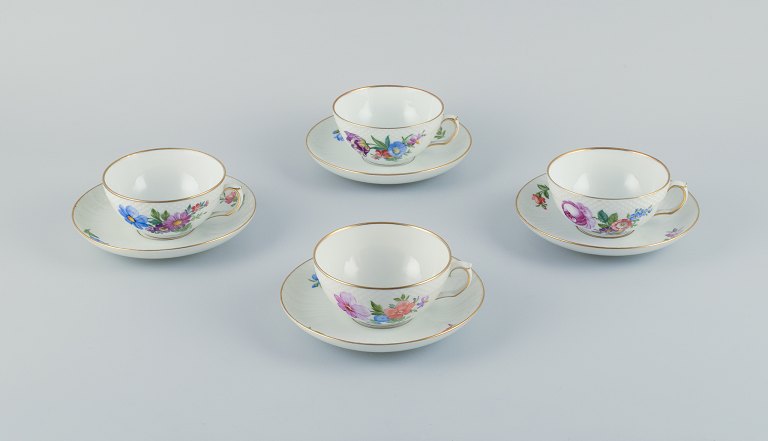 Royal Copenhagen, Saxon Flower, a set of four tea cups with saucers 
hand-decorated with polychrome flowers and gold rim.